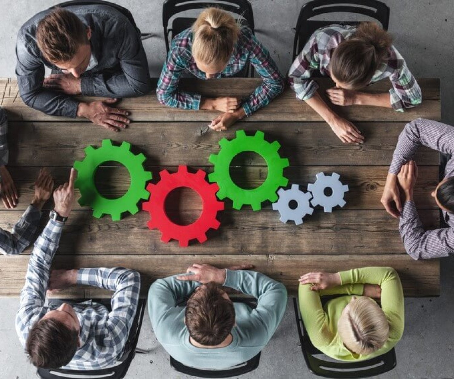 Hipster business team and cogs brainstorming planning meeting concept